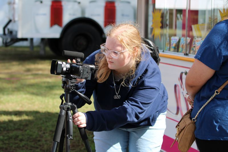 Student operating a camera