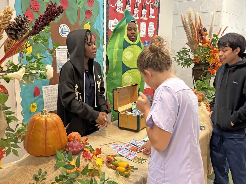 Students at a fall themed display