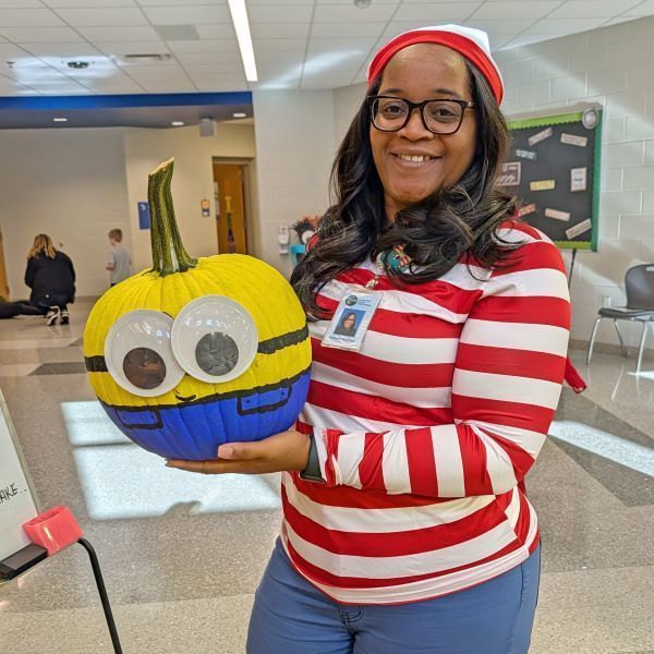 Staff holding a decorated pumpkin