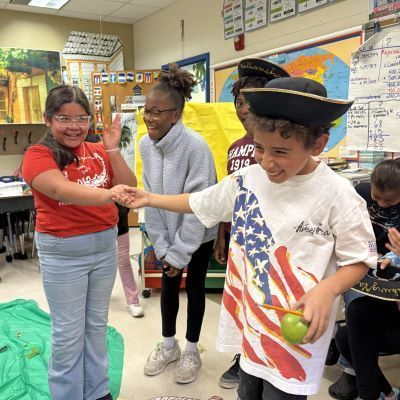 Students shaking hands and laughing