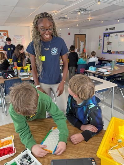 Older student helping younger students