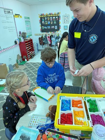 Old student helping younger students