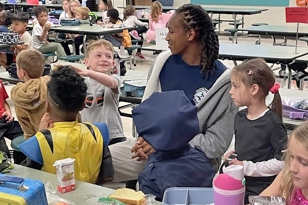 Younger student laughing with older student
