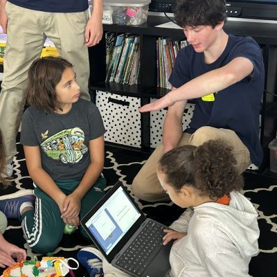 Older student working with younger students