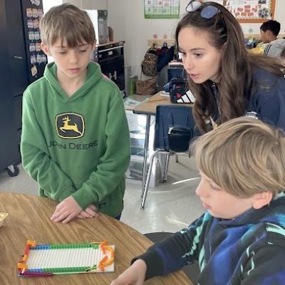 Older student helping younger students