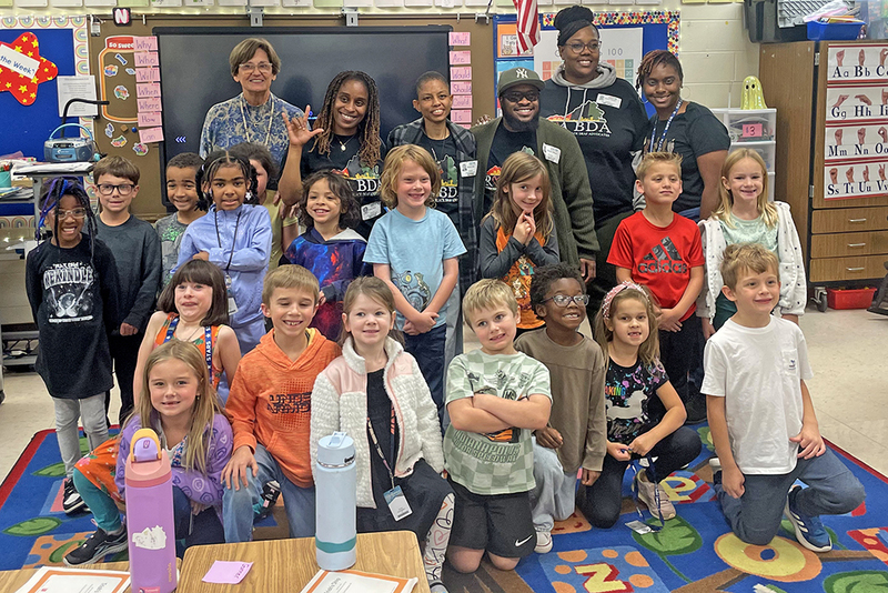 Visitors teaching the students to sign