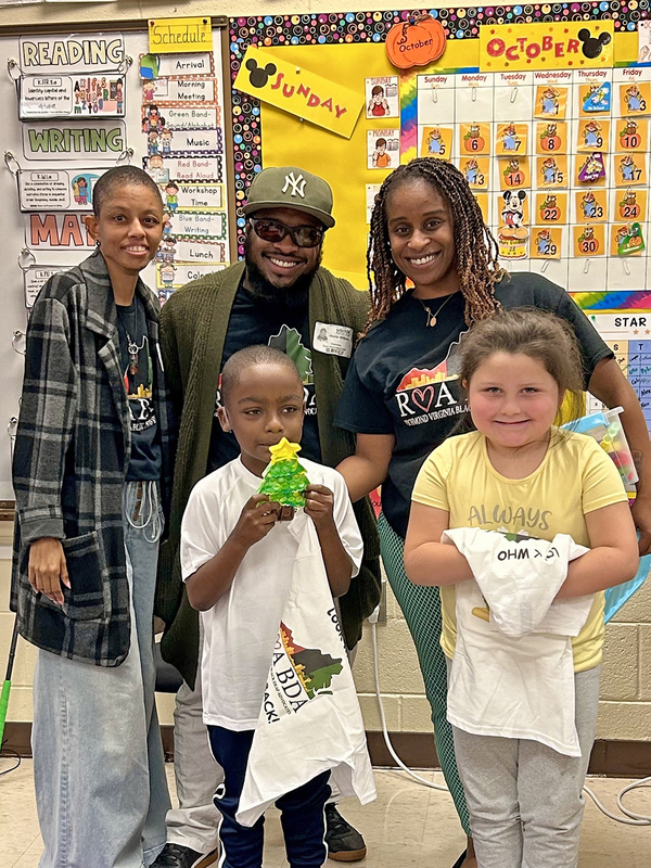 Visitors teaching the students to sign