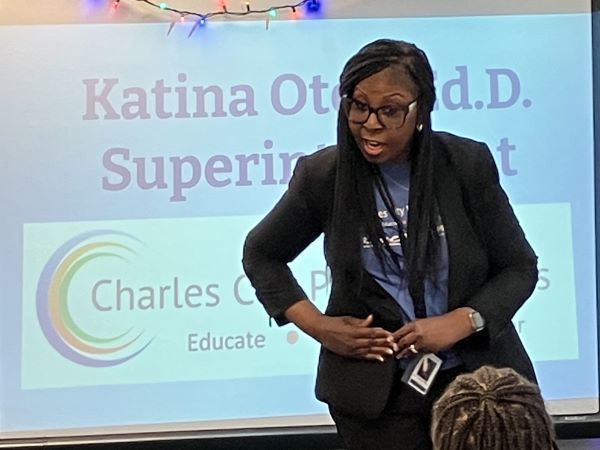 Woman in a suit speaking to a class