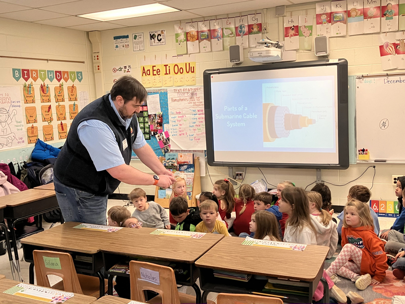 Man demonstrating an item in a class