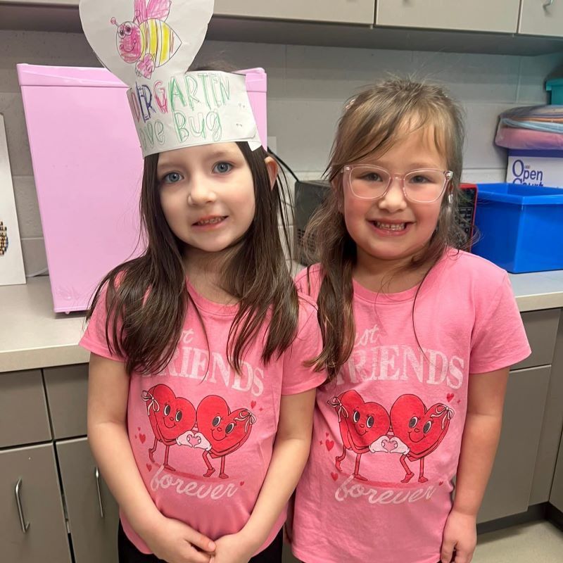 Two girls in pink shirts that say "Friends"