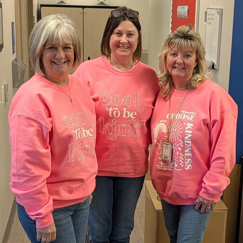 Office staff with shirts that say "Cool to be kind"