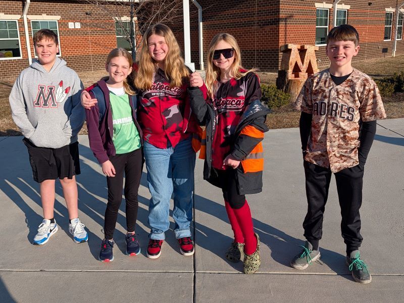 Older students in team jerseys
