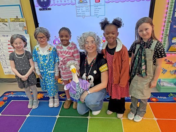 Kids and teachers dressed as 100-year-olds