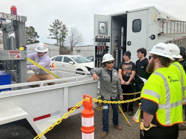 Dominion Energy workers demonstrating equipment