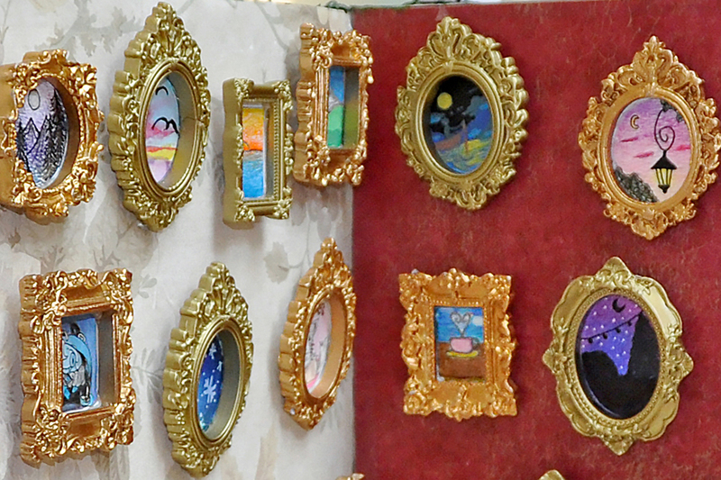 Students and parents looking at art in mall at art show