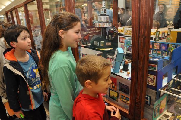 kids looking at mini artworks