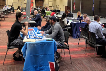 Large room with students interviewing at tables