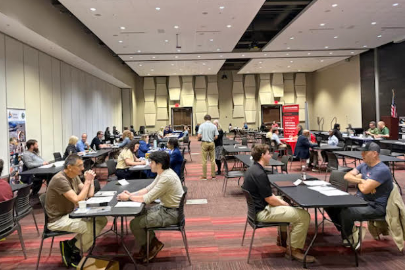 Large room with students interviewing at tables