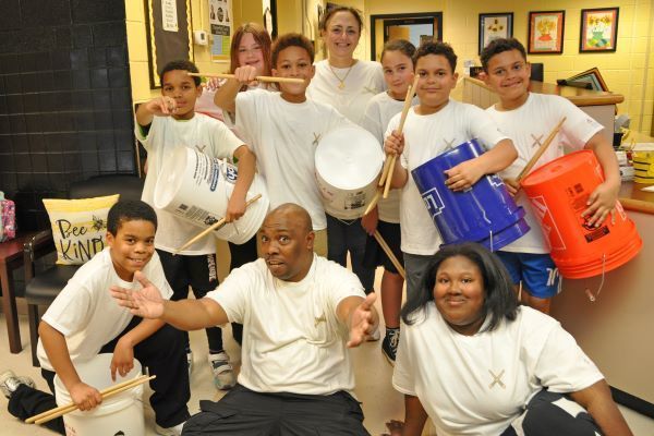 Students with bucket drums posing for the camera