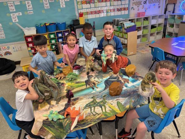 Children playing with dinosaur toys