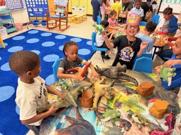 Children playing with dinosaur toys