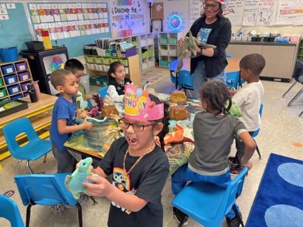 Students playing with dinosaurs