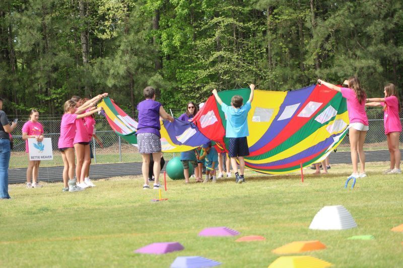 Students waving a large parachute