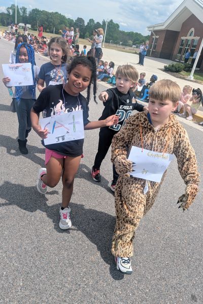 Students parading with letter signs