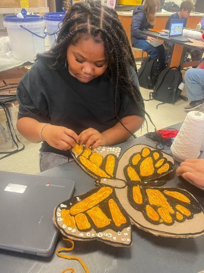 Student making butterfly art