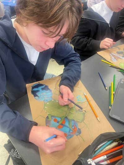 Student making butterfly art