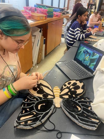 Student making butterfly art