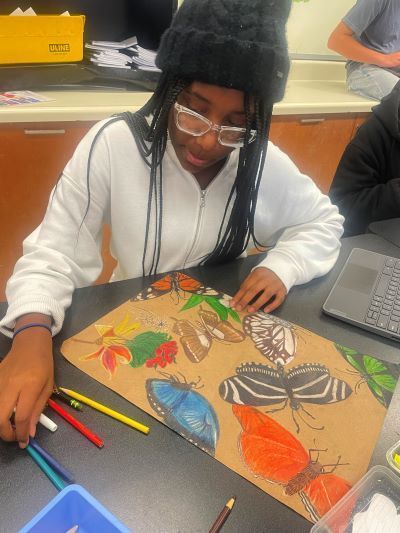 Student making butterfly art