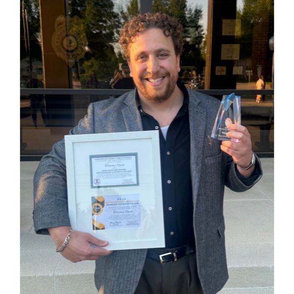 Tommy Ryan holding an award