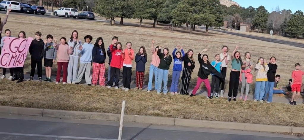 Gold Camp Elementary students and staff packed the sidewalk outside, cheering loud and proud as they sent the CMHS girls swimming and diving state team off to state—Go Hawks!