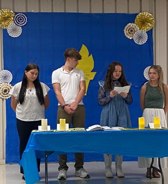 Vice President, Hayley Jenkins, reading the charge of Service