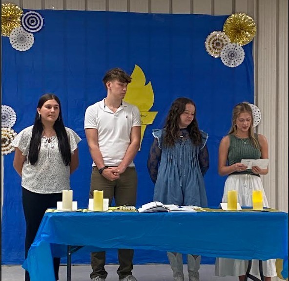 President, Lauren Gardner, reading the charge of Scholarship