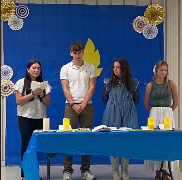 Treasurer, Bailey Coulter, reading the charge of Character