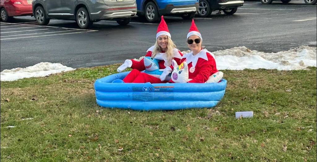 Two elves in an inflatable pool