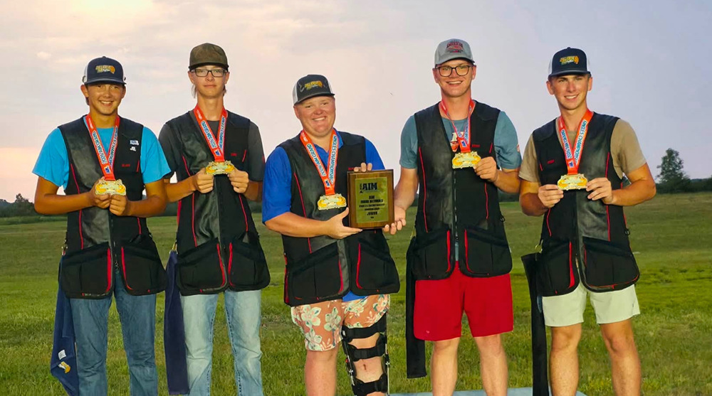 Chillicothe FFA Trap Team members pose together wearing their medals and holding the 2026 AIM Grand Nationals Overall Junior National Championship plaque after winning the title with a score of 975 out of 1,000 targets.