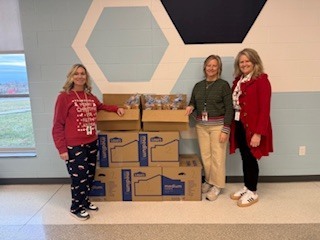 CES Couselors in front of donated food boxes.