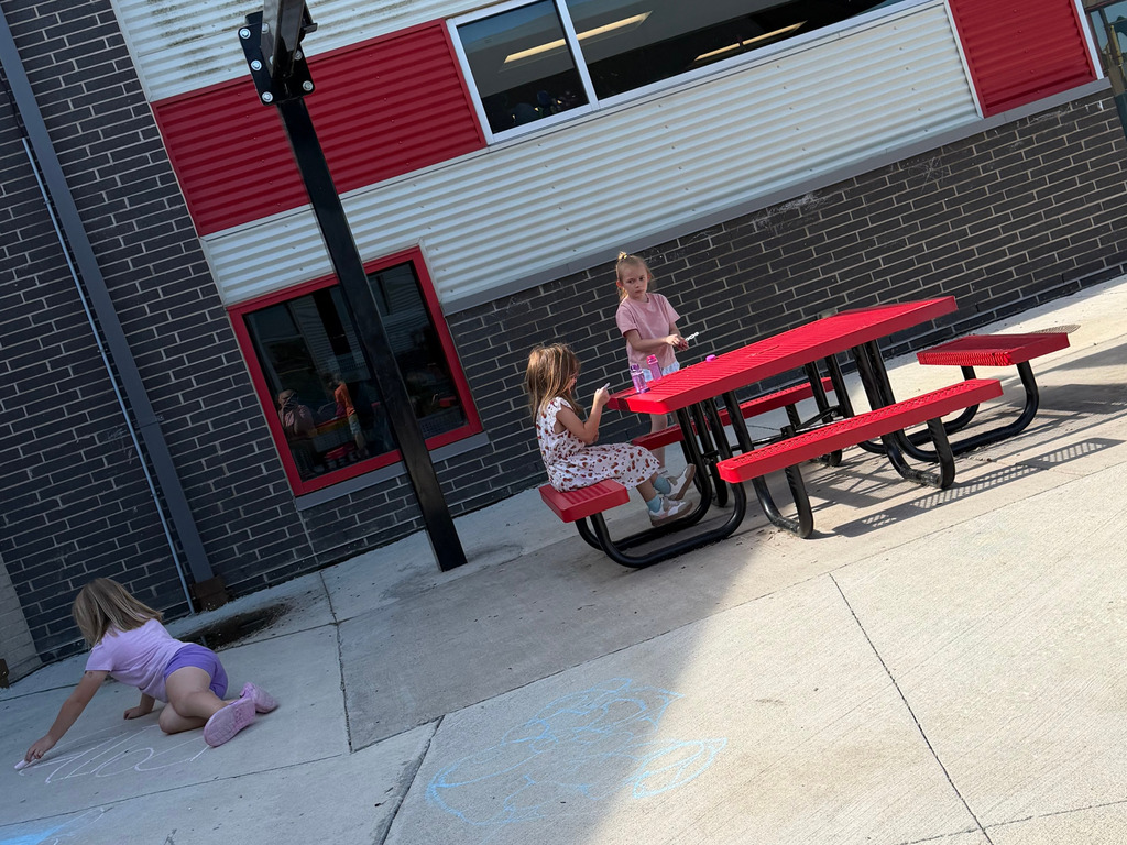Summer School kinds having fun at CES outside with chalk on the sidewalk.