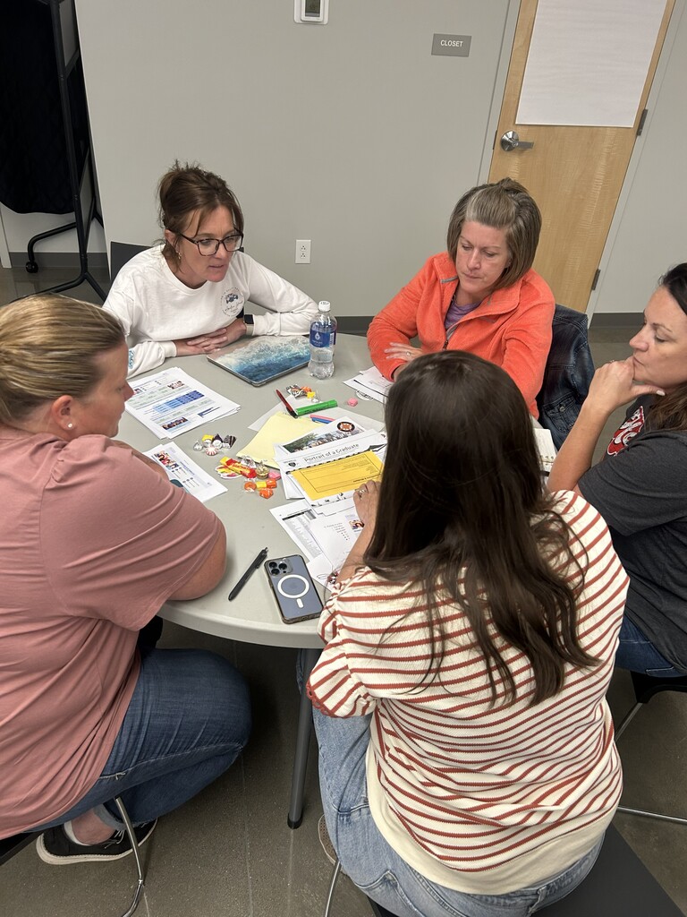 Terria Cox, Danielle Costner, Abby Smith, and others, work around around a table during a recent CSIP Meeting