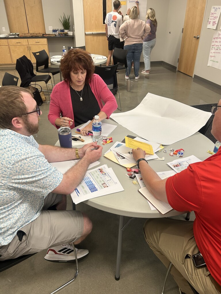 Dr. Dan Wiebers, Zeb Yoko and Nancy Burtch work around a table during a recent CSIP Meeting.