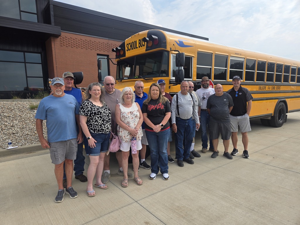 A group of Chillicothe R-II Bus Drivers standing near a school bus after a bus driver meeting at the Administratitve Offices, 2807 Hornet Road.