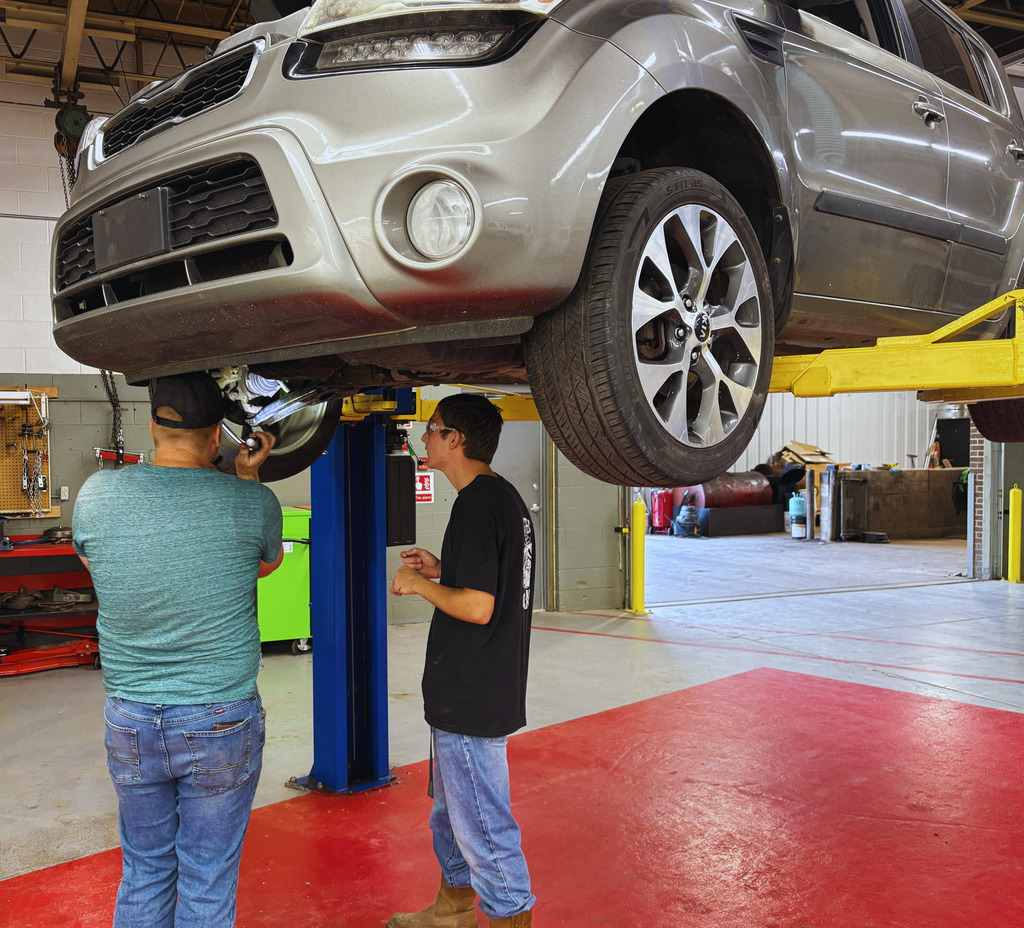 GRTS Auto Tech students working under a vehicle at the GRTS.