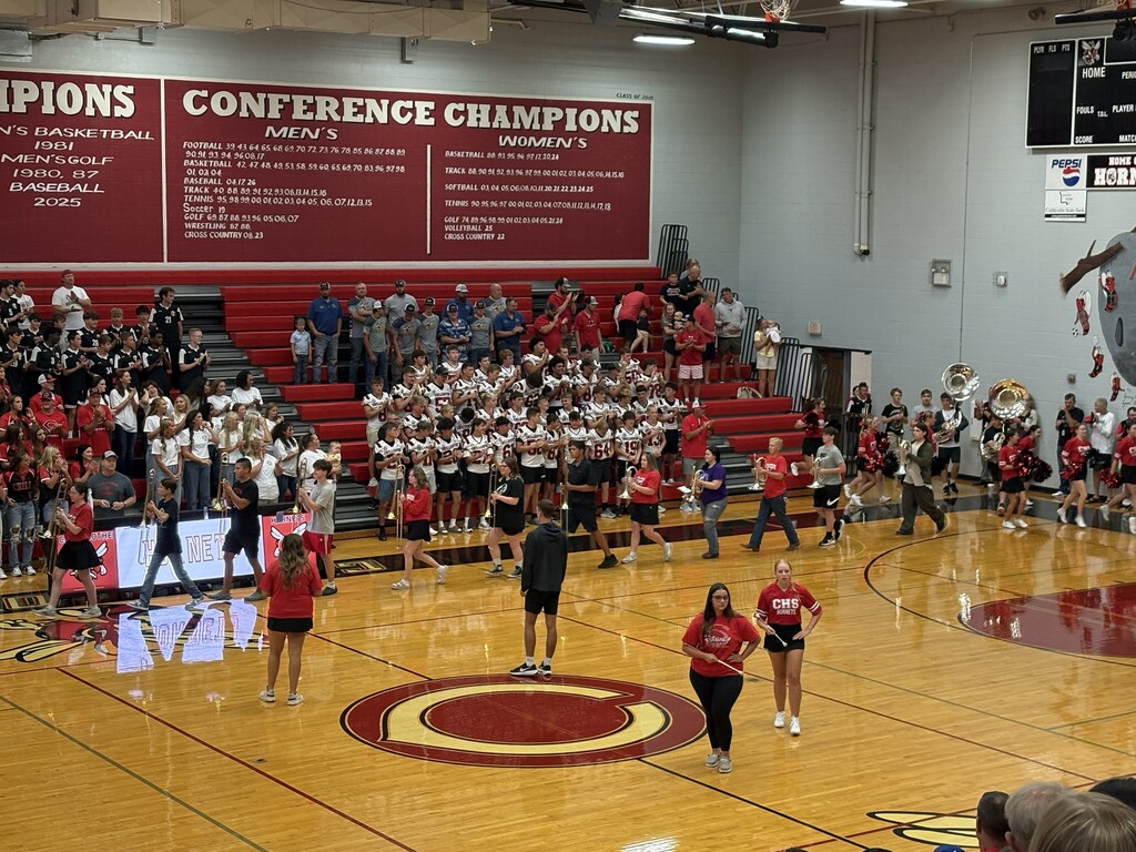The CHS Marching Hornets march onto the gymnasium floor playing their instruments  during Meet the Hornets last night.