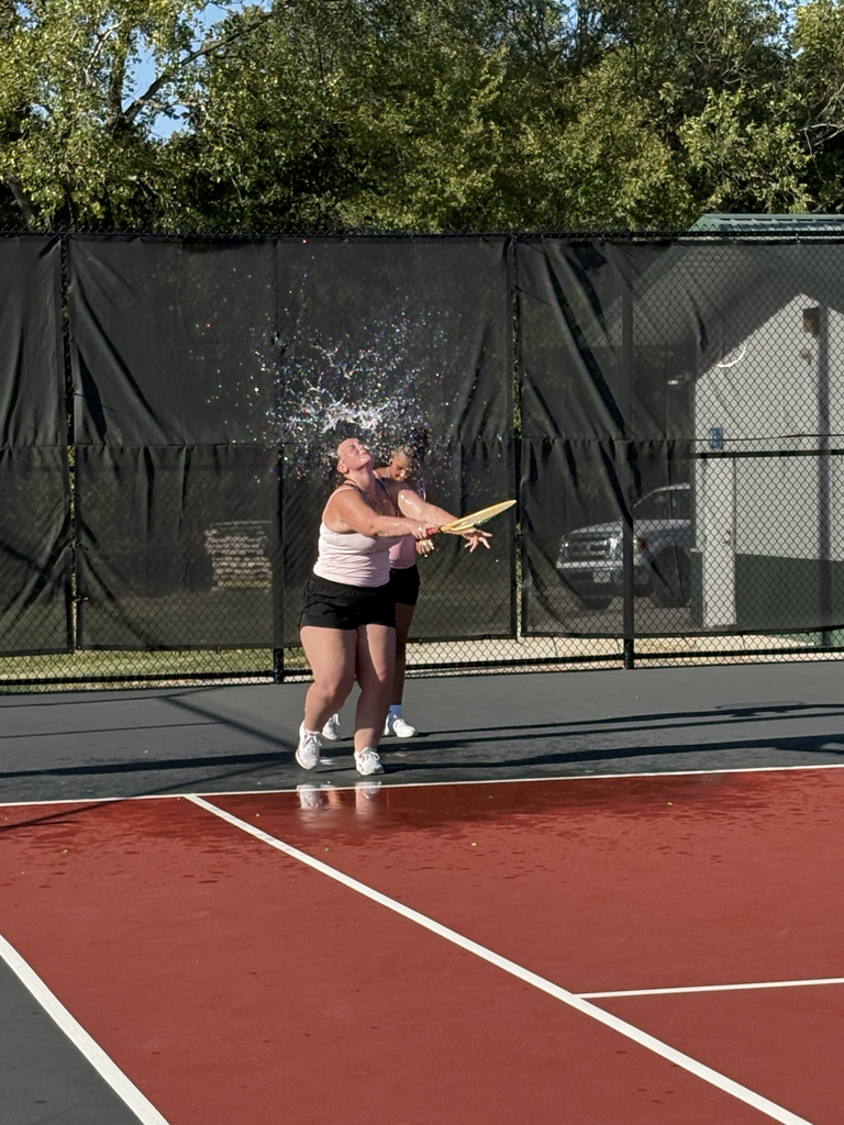 A tennis player cooling off after tennis practice Thursday by hitting a water balloon instead of a tennis ball at Danner Park tennis courts.