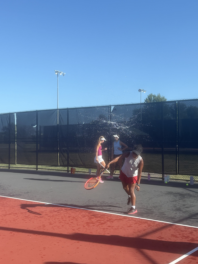 A tennis player cooling off after tennis practice Thursday by hitting a water balloon instead of a tennis ball at Danner Park tennis courts.