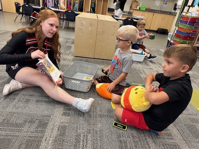 ECP Studnt reading to students.