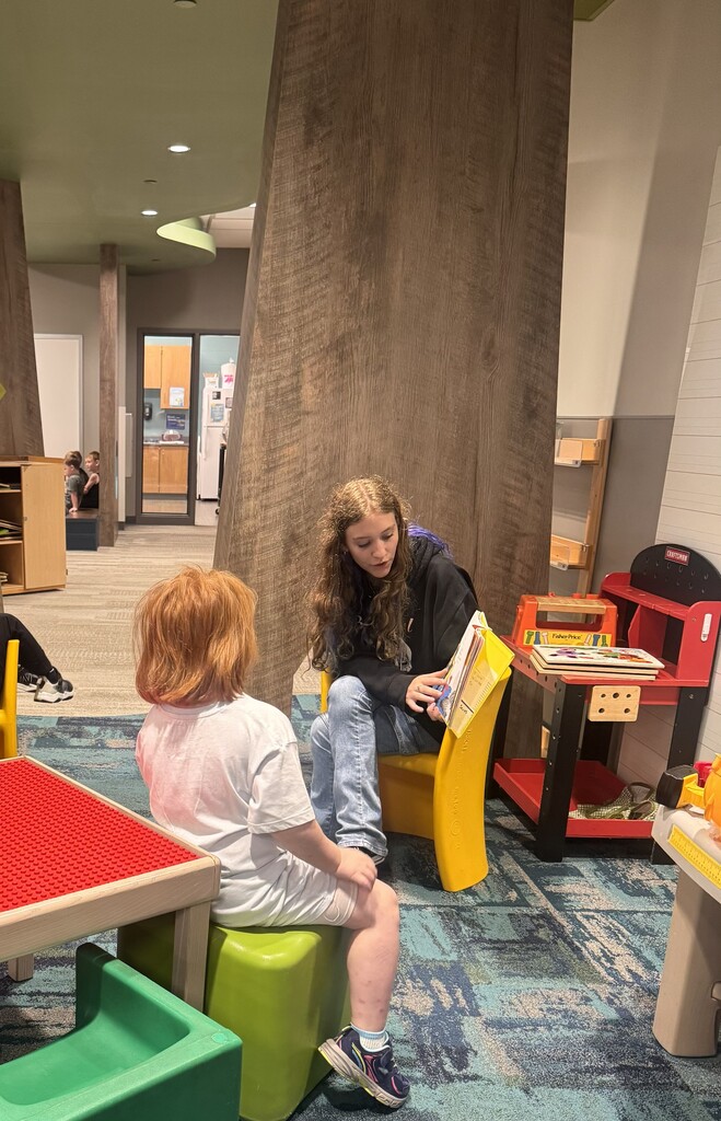 A CHS student reading to Pre-K students.